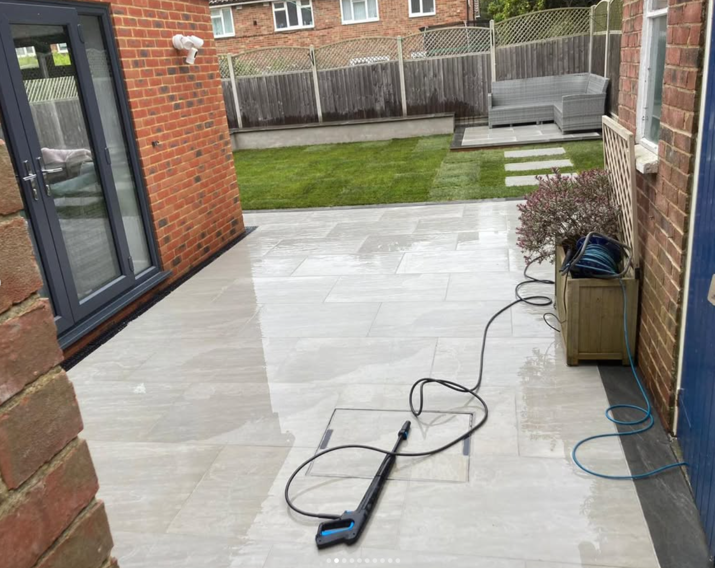 Paved patio leading from the house to a garden seating area