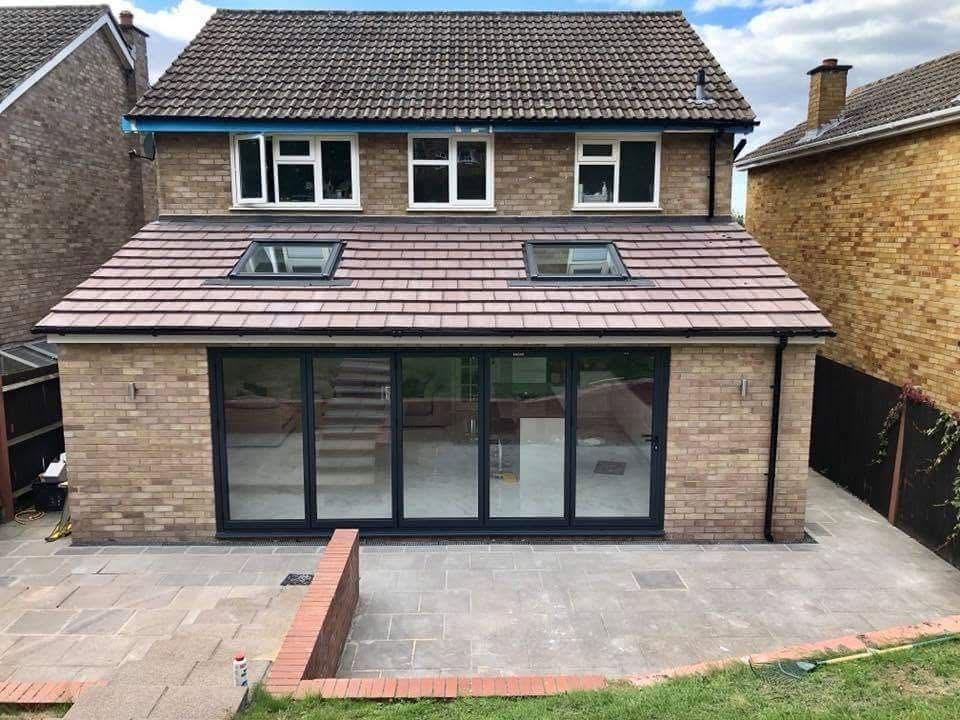 Rear extension with roof windows, glazed doors and a paved terrace