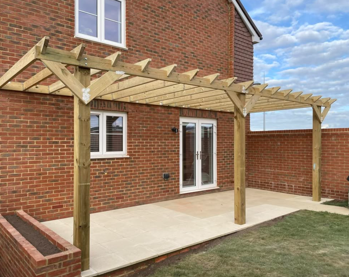 Timber pergola above a paved patio